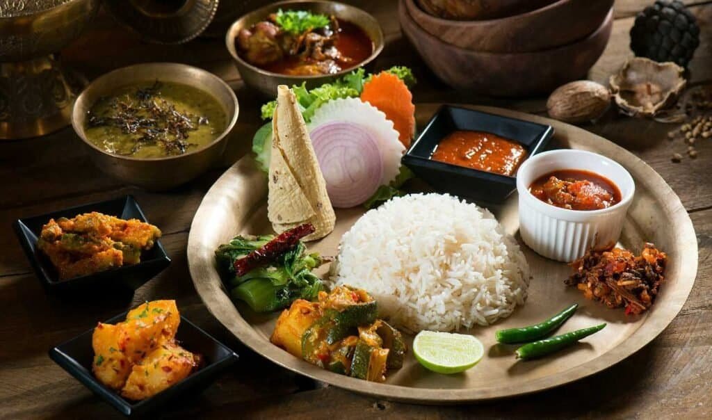 Traditional Nepali meal rice, dal (lentil soup), curry, pickles, and various sides